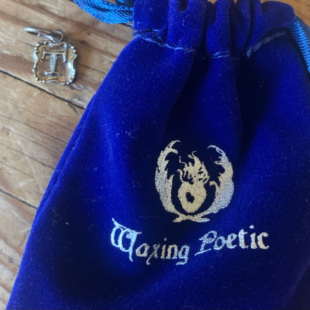 Waxing Poetic Crest Insignia “T” Charm